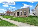 Beautifully landscaped home on a corner lot, with a lush green lawn and a tidy sidewalk at 14444 Black Farm Dr, Noblesville, IN 46060