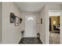 Inviting foyer with a decorative rug, a welcoming sign, and a view into the office at 14444 Black Farm Dr, Noblesville, IN 46060