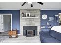 Cozy fireplace with stone surround and mantel, set against blue paneled walls, creating a focal point in the living space at 1527 N Washington St, Danville, IN 46122