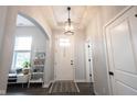 Bright foyer with white walls, hardwood floors, and a decorative pendant light fixture at 1534 Cloverdon Dr, Westfield, IN 46074