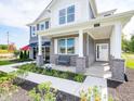 Inviting front porch with gray brick and a bench perfect for relaxing at 1571 Beyers St, Fortville, IN 46040