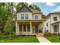 Lovely home with a welcoming front porch, nice landscaping, and healthy lawn at 1818 Central Ave, Indianapolis, IN 46202