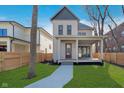 Beautiful two-story home featuring a cozy front porch and green lawn at 1818 Central Ave, Indianapolis, IN 46202