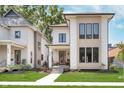 New construction home with white siding, black trim and a covered front porch at 1822 Central Ave, Indianapolis, IN 46202