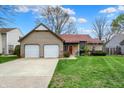 Charming home with an attached two-car garage and a well-maintained lawn, offering great curb appeal at 1829 Catalano Dr, Indianapolis, IN 46214