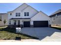 Charming two-story white home with a two-car garage, landscaped yard, and a welcoming front porch at 18944 Seaforth Way, Westfield, IN 46074