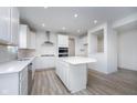 Modern kitchen showcasing a center island, white cabinets, and stainless steel appliances at 18944 Seaforth Way, Westfield, IN 46074