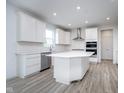 Bright kitchen featuring white cabinets, stainless steel appliances, and a large island at 18944 Seaforth Way, Westfield, IN 46074