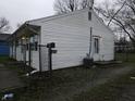 The house has a side door, air conditioning unit, and a chain link fence at 1931 Brentwood Dr, Anderson, IN 46011
