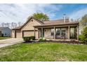 Charming brick home featuring a two-car garage, covered porch, and well-maintained lawn at 2034 Milburn Dr, Brownsburg, IN 46112