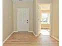 Spacious entryway with wood flooring and natural light, showcasing the home's interior at 2206 Tansel Crossing Cir, Indianapolis, IN 46234