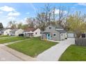 Neighborhood street view featuring a renovated home with a crushed gravel driveway at 2249 N Centennial St, Indianapolis, IN 46222