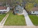 Aerial view of a well-maintained home with lush green lawn and gravel driveway at 2249 N Centennial St, Indianapolis, IN 46222
