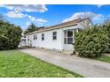 Charming one-story home with a well-maintained lawn and a concrete driveway at 2330 Harlan St, Indianapolis, IN 46203