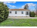 Lovely one-story home with a bright white exterior and manicured front yard at 2330 Harlan St, Indianapolis, IN 46203