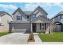Charming two-story home with a gray exterior, well-manicured lawn, and a spacious two-car garage at 2741 Penn Ave, Plainfield, IN 46168