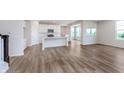Open-concept kitchen with white cabinets, stainless steel appliances, and an island with a sink at 2741 Penn Ave, Plainfield, IN 46168