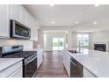 Modern kitchen with stainless steel appliances, center island with seating, and white cabinetry at 2741 Penn Ave, Plainfield, IN 46168