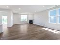 Bright, open living room with wood floors, a fireplace, and abundant natural light from large windows at 2741 Penn Ave, Plainfield, IN 46168