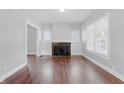 Living room with a fireplace, built-in shelves, hardwood floors, and natural light at 402 W 38Th St, Indianapolis, IN 46208