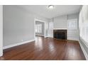 A brightly lit living room featuring hardwood floors and view into another room at 402 W 38Th St, Indianapolis, IN 46208