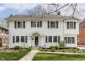 A welcoming two-story white home with classic design, landscaped garden, and inviting front entrance at 4451 N Washington Blvd, Indianapolis, IN 46205