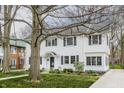 Traditional white home with dark shutters and a mature tree in a quiet residential neighborhood at 4451 N Washington Blvd, Indianapolis, IN 46205