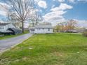 Charming single story home with a spacious lawn, driveway, and attached garage at 4897 Walker St, Greenwood, IN 46143