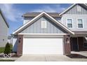 Close-up of the home's two-car garage, showcasing its brick accents and well-maintained exterior at 5051 Arling Ct, Indianapolis, IN 46237