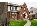 Beautiful brick Tudor home featuring a unique front facade and inviting landscaping at 5157 N New Jersey St, Indianapolis, IN 46205