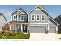 Charming two-story home featuring a three-car garage, complemented by a well-manicured lawn and mature landscaping at 5300 Veranda Dr, Noblesville, IN 46062