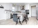 Bright kitchen with white cabinets, island with seating, stainless appliances, and modern backsplash at 5300 Veranda Dr, Noblesville, IN 46062