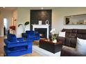 Inviting living room with a fireplace and stacked stone wall, plus plush blue chairs and comfortable seating at 5300 Veranda Dr, Noblesville, IN 46062
