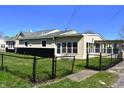 A fenced backyard featuring a sunroom and black accents on the exterior at 601 Duane St, Franklin, IN 46131