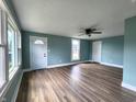 Spacious living room featuring laminate floors, fresh blue paint, and newer windows and trim at 601 Duane St, Franklin, IN 46131