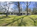 Charming ranch-style home featuring a beautiful lawn and mature trees in a desirable neighborhood at 6025 Crows Nest Dr, Indianapolis, IN 46228