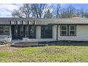 Beautiful white brick home with a dark front door, modern lighting, and a professionally landscaped front yard at 6025 Crows Nest Dr, Indianapolis, IN 46228