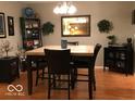 Comfortable dining area with wooden table, chairs, and decorative accents at 6525 Emerald Hill Ct # 208, Indianapolis, IN 46237