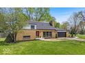 Charming brick home featuring a well-manicured lawn and attached garage, perfect for comfortable suburban living at 7205 Steven Ln, Indianapolis, IN 46260