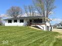 Beautifully renovated home with a covered porch, an attached two-car garage and a large, sloping front yard at 7440 S 250 W, Pendleton, IN 46064