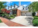 Lovely two-story brick home with attached two-car garage, well-maintained lawn, and a brick walkway at 8089 Lynch Ln, Indianapolis, IN 46250