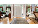Inviting foyer featuring hardwood floors, a decorative rug, and a traditional front door with sidelights at 8089 Lynch Ln, Indianapolis, IN 46250