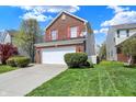 Well-maintained brick two-story home with a two-car garage and manicured lawn, enhancing its curb appeal at 8116 Barksdale Way, Indianapolis, IN 46216