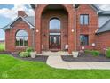 Elegant front entrance with a decorative door, sidelights, and manicured landscaping, creating curb appeal at 8362 N County Road 650 E, Brownsburg, IN 46112