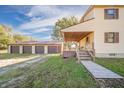 Home with a covered porch and attached three-car garage at 9056 E 650 N, Wilkinson, IN 46186