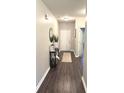 Inviting entryway featuring wood-look floors, a decorative table, and a white front door at 914 Baden Manor Dr, Indianapolis, IN 46217