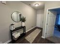 Inviting entryway with sleek dark wood flooring, stylish console table, and contemporary decor at 914 Baden Manor Dr, Indianapolis, IN 46217