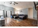 Spacious living room with vaulted ceilings, a cozy fireplace, and hardwood floors at 9531 Charter Dr, Indianapolis, IN 46250