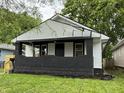 Charming home featuring a freshly painted exterior, well-maintained lawn, and quaint front porch at 1032 Groff Ave, Indianapolis, IN 46222