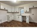 Bright kitchen featuring modern white cabinets, sleek black hardware, subway tile backsplash, and new countertops at 1032 Groff Ave, Indianapolis, IN 46222